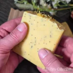 Sunlit Citrus Tallow Soap side view showing poppy seeds dispersed throughout golden yellow bar