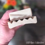 Curved alder wood soap saver dish shown from above with open slotted design visible