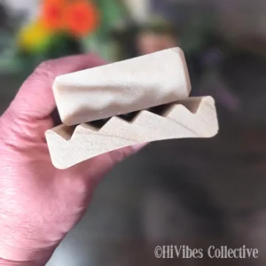 Curved alder wood soap saver dish shown from above with open slotted design visible
