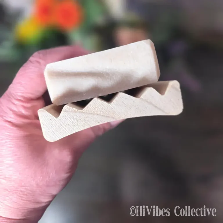 Curved alder wood soap saver dish shown from above with open slotted design visible