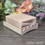 Curved alder wood soap dish with gently arched base and slotted surface for drainage and airflow