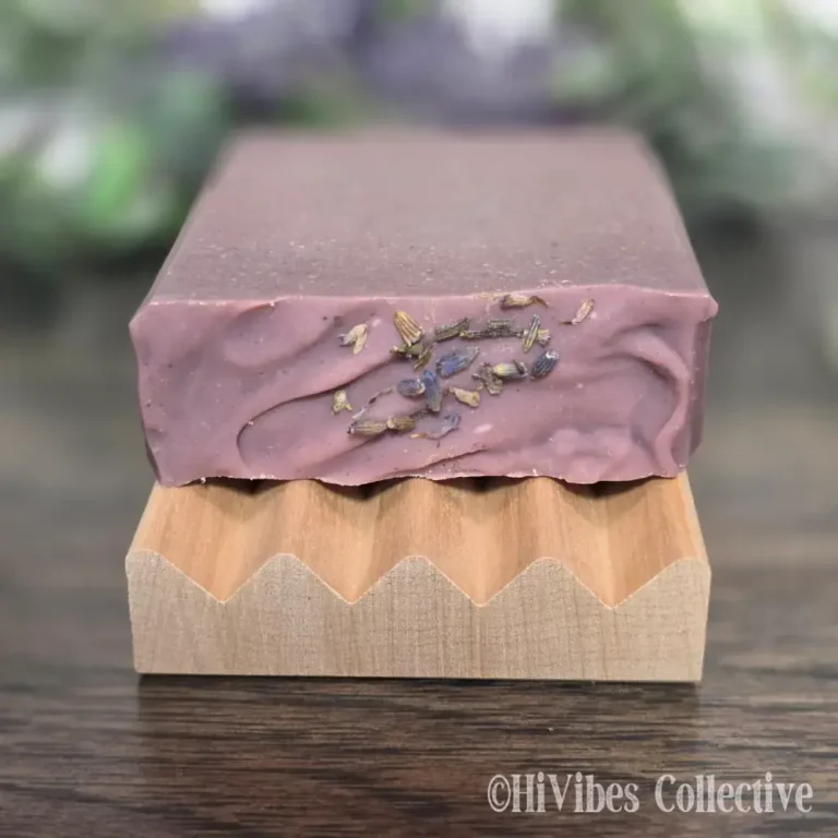 Violet and Mint Tallow Soap top view showing lavender buds on dark purple rhubarb-infused tallow bar