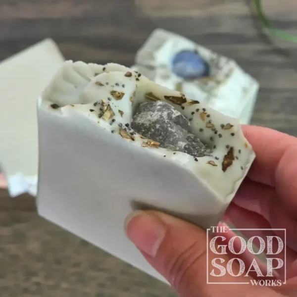 Throat Chakra Soap with Raw Blue Calcite - in hand showing top view