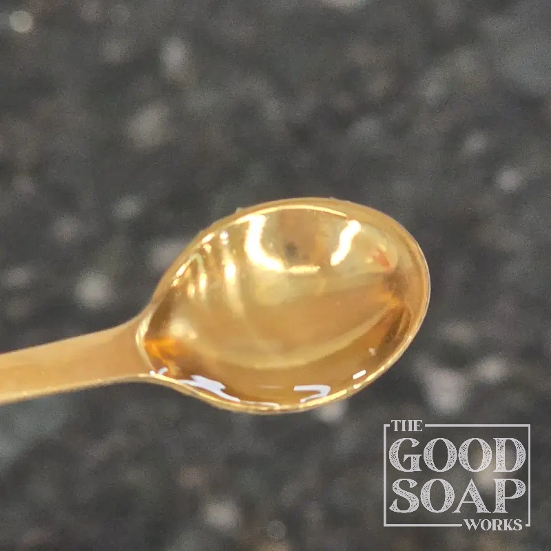 Close-up of AMTicide Coconut on a spoon, a natural preservative ingredient used by The Good Soap Works Co.