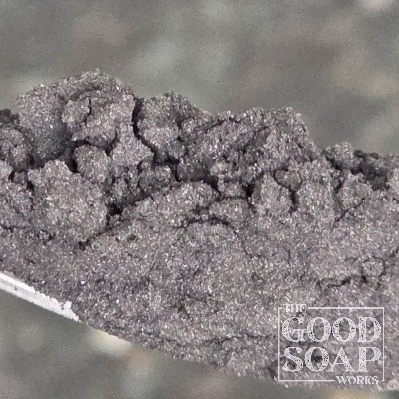 Close-up of Activated Charcoal powder on a spoon, a detoxifying ingredient used in soap and skincare by The Good Soap Works Co.