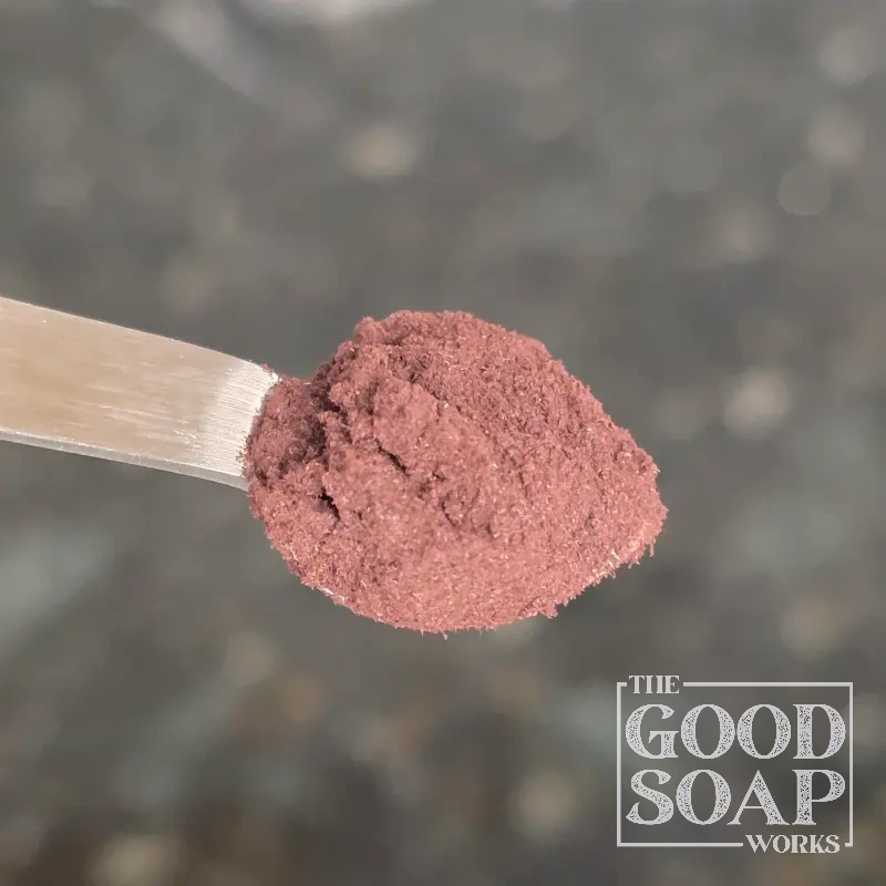 Close-up of Alkanet Root powder on a spoon, a natural colorant ingredient used in soap by The Good Soap Works Co.