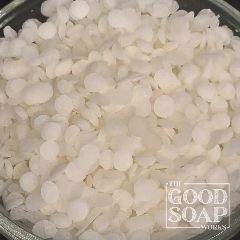 Beeswax pastilles displayed in a small bowl, a natural wax ingredient used in soap and skincare by The Good Soap Works Co.