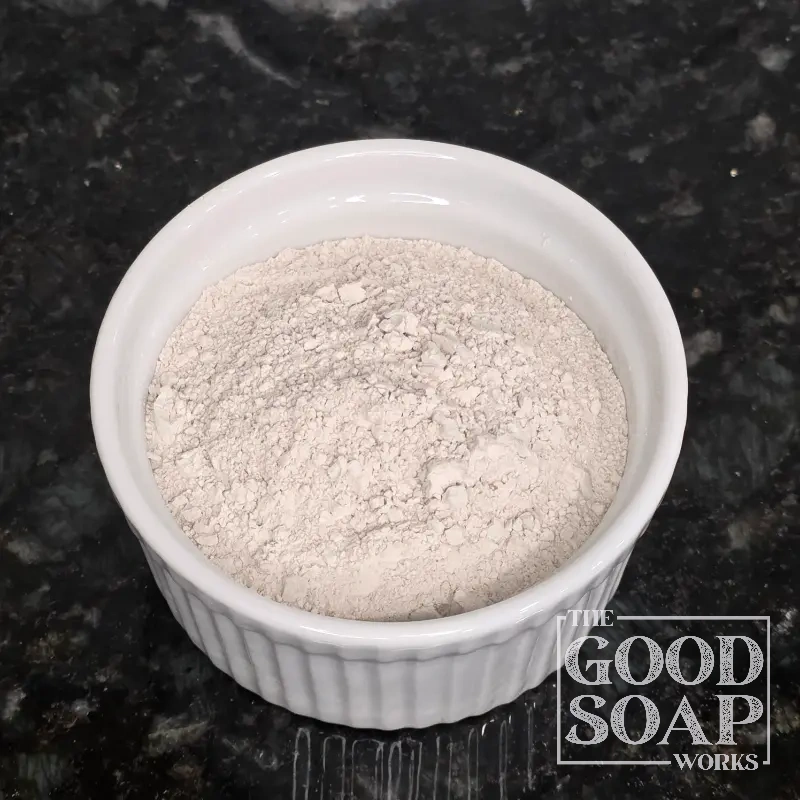 Close-up of Bentonite Clay powder on a spoon, a detoxifying ingredient used in soap and skincare by The Good Soap Works Co.