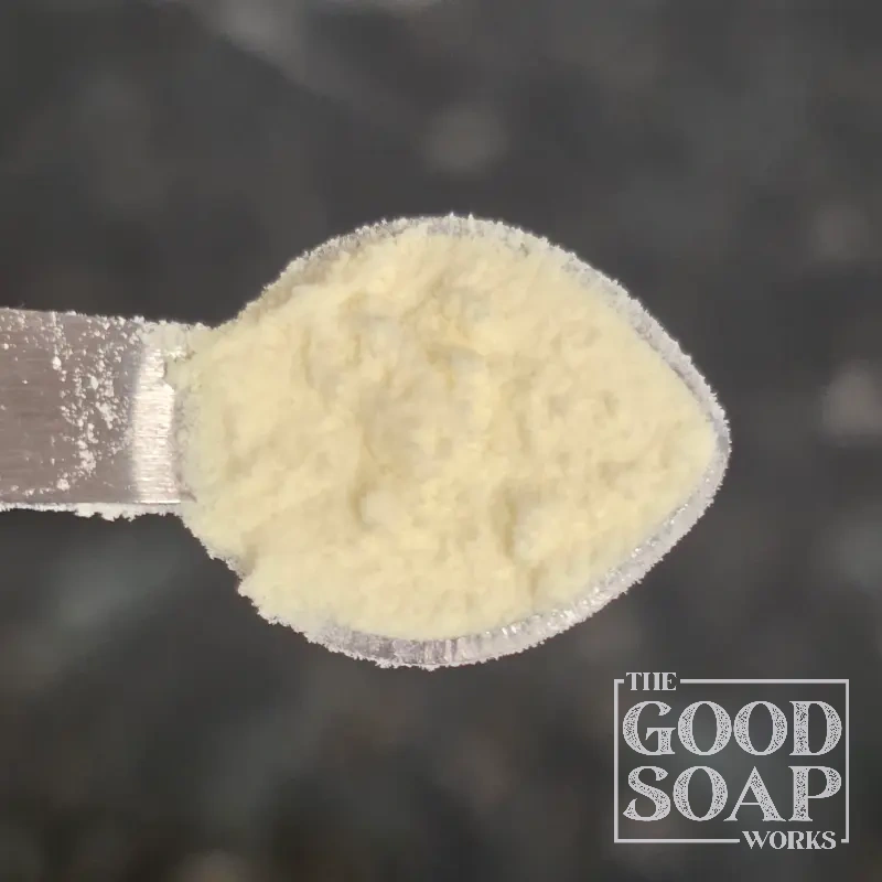 Close-up of Cationic Guar Gum powder on a spoon, a conditioning ingredient used in soap and skincare by The Good Soap Works Co.