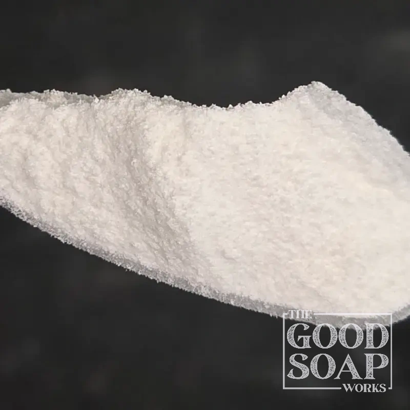 Close-up of Disodium 2-Sulfolaurate powder on a spoon, a surfactant ingredient used in soap by The Good Soap Works Co.