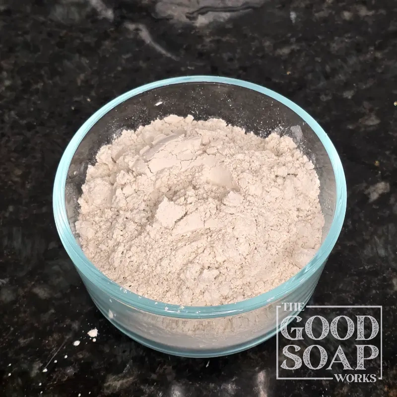 Close-up of Diatomaceous Earth powder on a spoon, an exfoliating ingredient used in soap and skincare by The Good Soap Works Co.
