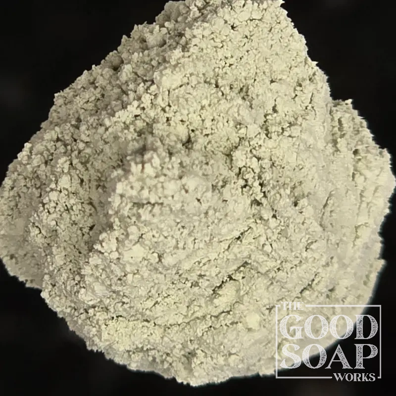 Close-up of French Green Clay powder on a spoon, a detoxifying ingredient used in soap and skincare by The Good Soap Works Co.