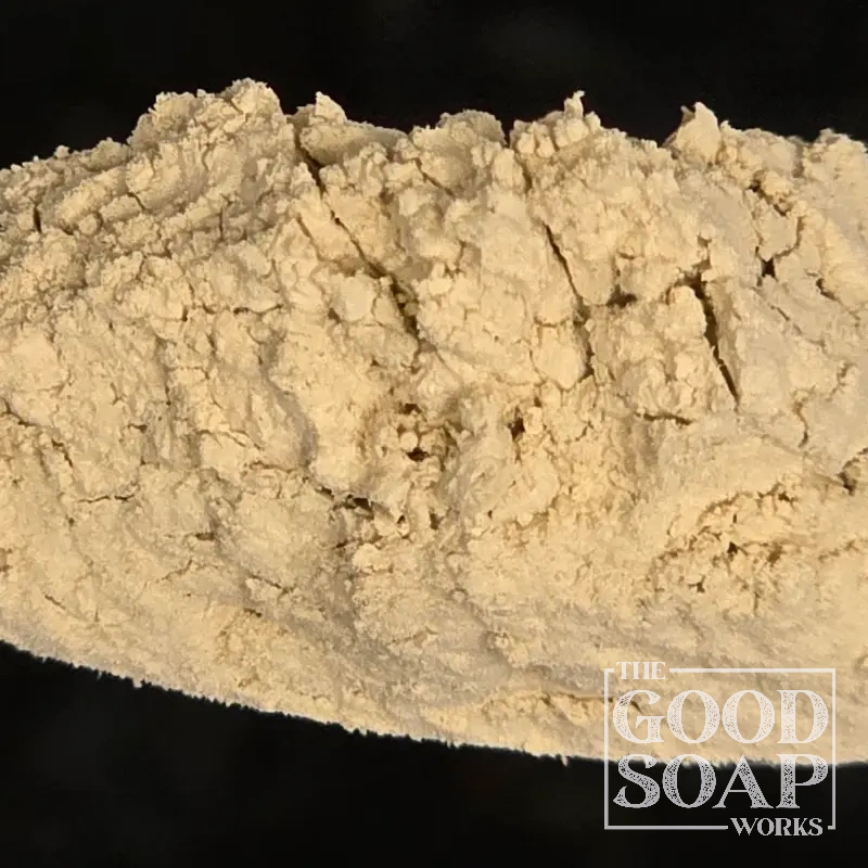 Close-up of Fuller's Earth clay powder on a spoon, a cleansing ingredient used in soap and skincare by The Good Soap Works Co.
