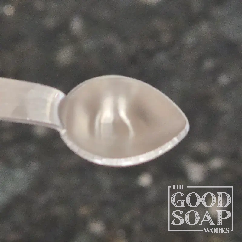 Close-up of Leucidal Liquid on a spoon, a natural preservative ingredient used by The Good Soap Works Co.