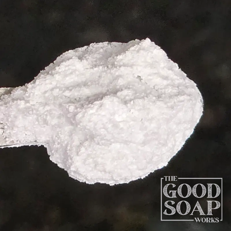 Close-up of Magnesium Hydroxide powder on a spoon, an ingredient used in soap and skincare by The Good Soap Works Co.