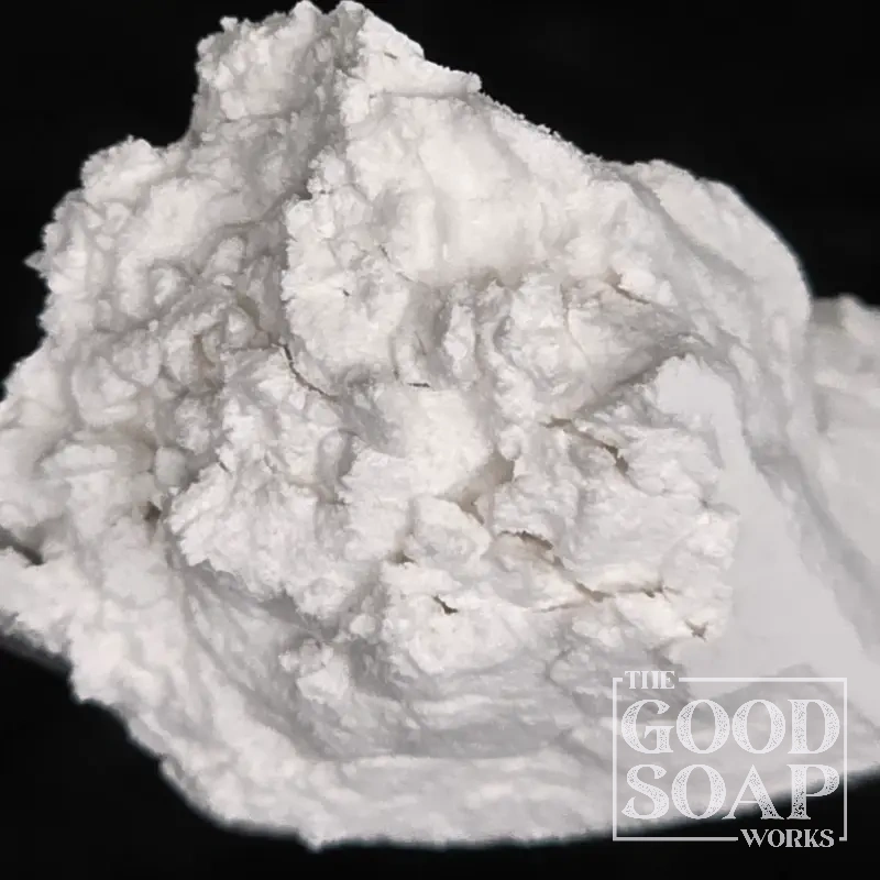 Pumice powder on a wooden spoon — a natural volcanic mineral used as an exfoliant in handmade soap
