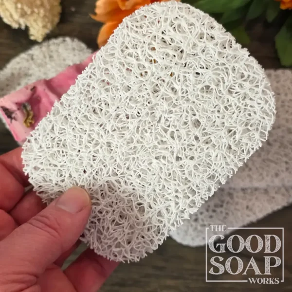 Compact soap saver pad in light grey, designed to lift soap above standing water for faster drying