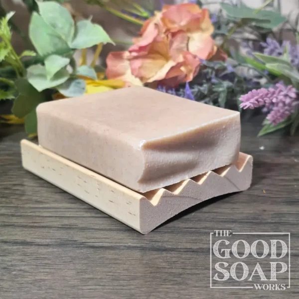 Curved alder wood soap dish with our Tallow & Goat Milk Soap to show size - Side View