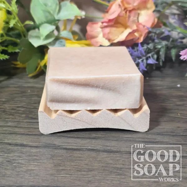 Curved alder wood soap dish with our Tallow & Goat Milk Soap to show size - Side View