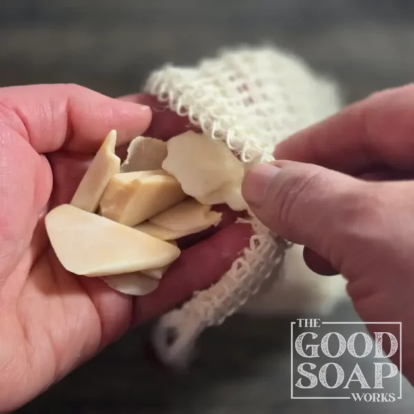 Sisal soap saver bag filled with small leftover soap scraps — a zero-waste way to use every last piece