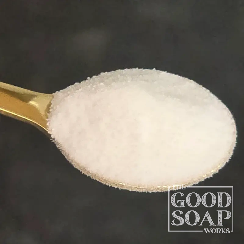 Stevia powder on a wooden spoon — a natural sweetener sometimes used in lip care and oral care products