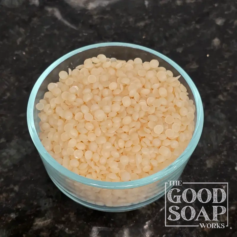 Close-up of Zinc Ricinoleate powder on a spoon, a natural deodorizing ingredient used in skincare by The Good Soap Works Co.